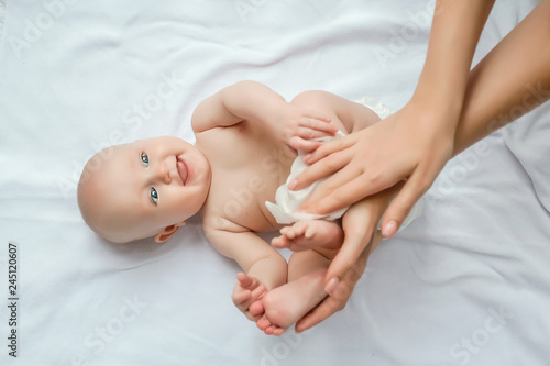 Mother cleaning up and wipes body and leg baby by wet tissue. Cleaning wipe, pure, clean. happy emotions of newborn baby photo