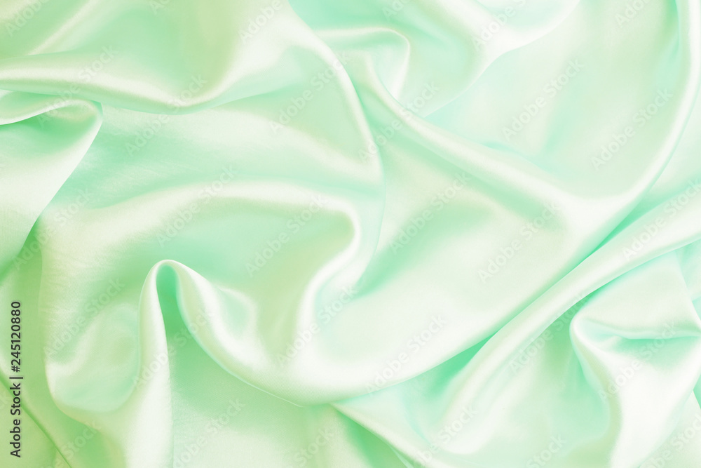 Smooth elegant green silk or satin texture can use as abstract background, fabric design Smooth elegant green silk or satin texture can use as abstract background, fabric design