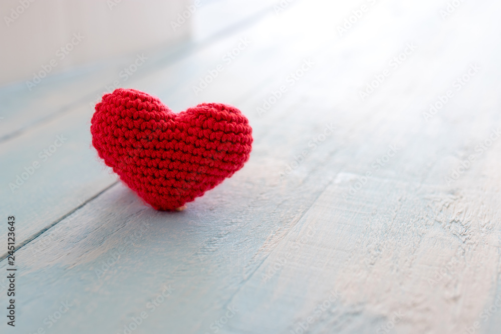 Fototapeta premium Heart made of red yarn on wooden background. Valentine day concept.