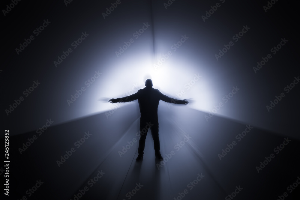 futuristic silhouette of man in a tunnel 