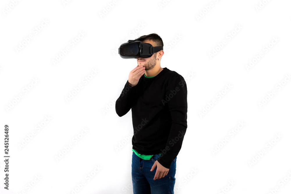 Bearded Thoughtful and confused young nice and modern with vr glasses that enjoy virtual reality with simulator isolated over white background Bearded Thoughtful and confused young nice and modern with vr glasses that enjoy virtual reality with simulator isolated over white background