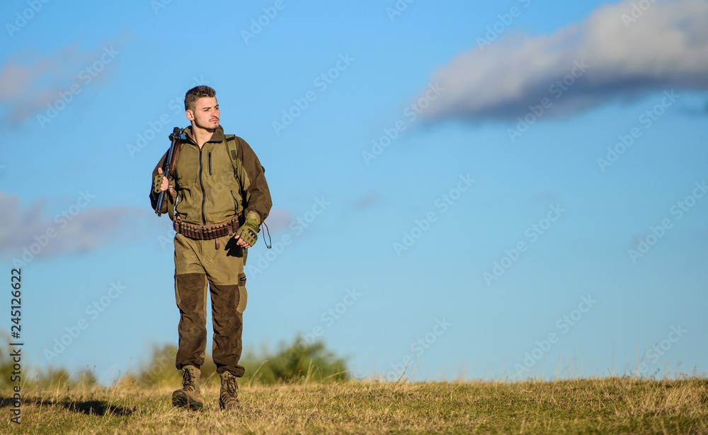 Hunting weapon gun or rifle. Hunting hobby. Guy hunting nature environment. Masculine hobby activity. Man hunter carry rifle blue sky background. Experience and practice lends success hunting