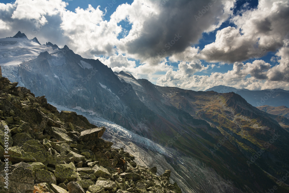 Fototapeta premium Landscape with Swiss alpine mountains with glaciers and sunset.