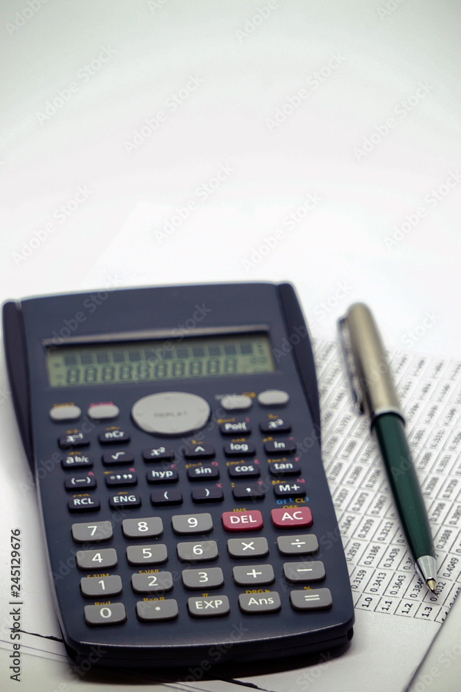 Calculator pen and statistics chart on white isolated background Calculator pen and statistics chart on white isolated background