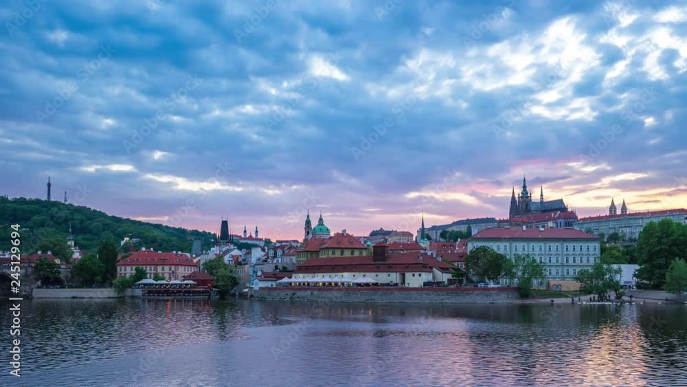 Prague city skyline with view of Vltava River in Prague, Czech Republic day to night time lapse