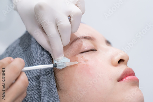 Doctors hands making an injection cosmetic in young woman face. Beauty Treatment.