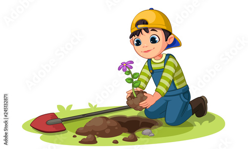Little boy planting small flower plant in the garden