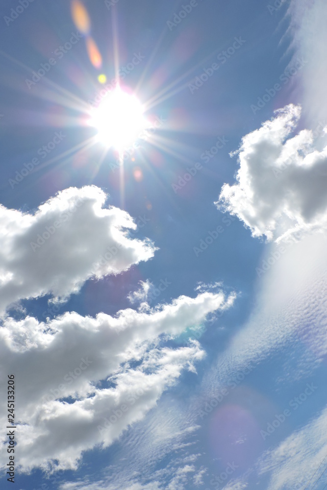 The Sun and white clouds in the blue sky - obrazy, fototapety, plakaty 