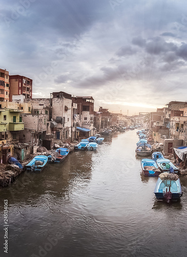 Dramatic sky and sunrise and boats in The Fishing Village of Al Maks  in Alexandria Egypt