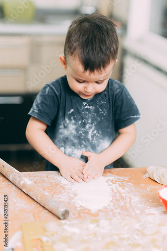 The child makes dough dumplings or dumplings is fun with enthusiasm