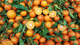 Orange fruit with leaves for sale on market