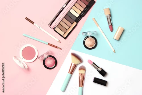 Obraz  professional makeup tools. Makeup products on a colored background top view. A set of various products for makeup.