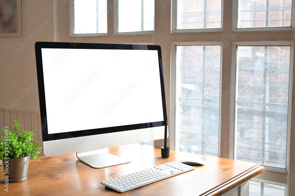Computer on workspace with wood table and mockup. Computer on workspace with wood table and mockup.