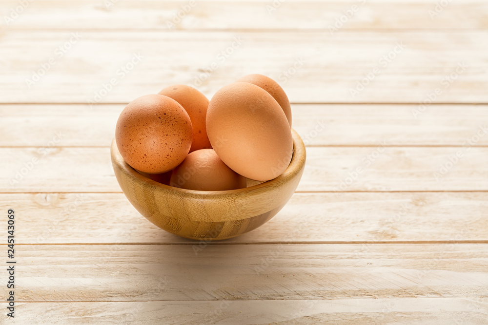 Bowl with egs on white wooden background Bowl with egs on white wooden background