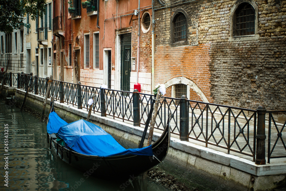 Venice architecture with gondola at the pier