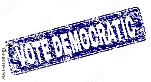 VOTE DEMOCRATIC stamp seal print with distress texture. Seal shape is a rounded rectangle with frame. Blue vector rubber print of VOTE DEMOCRATIC label with unclean texture.