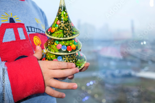 New Year toy tree on the kid hands