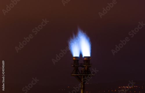 burning blue fire flame on a pipe factory.