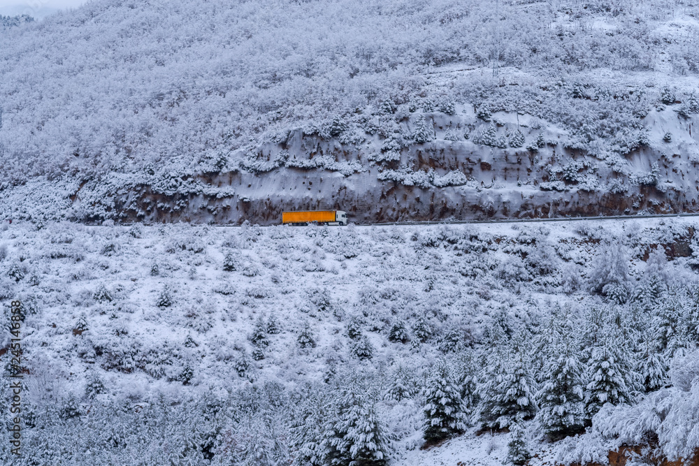 Truck in a snow covered mountain scene Truck in a snow covered mountain scene
