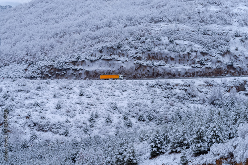 Truck in a snow covered mountain scene