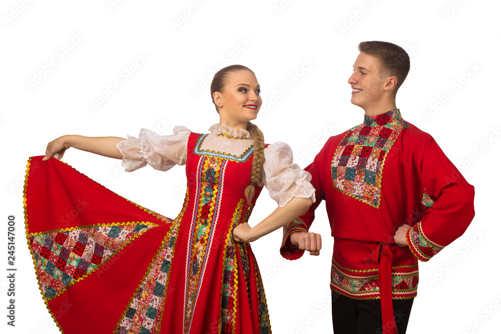Beautiful caucasian couple dancing in Russian folk costumes isolated on white