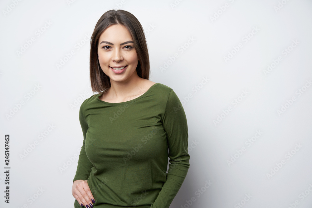 Young smiling brunette woman looking at camera Young smiling brunette woman looking at camera