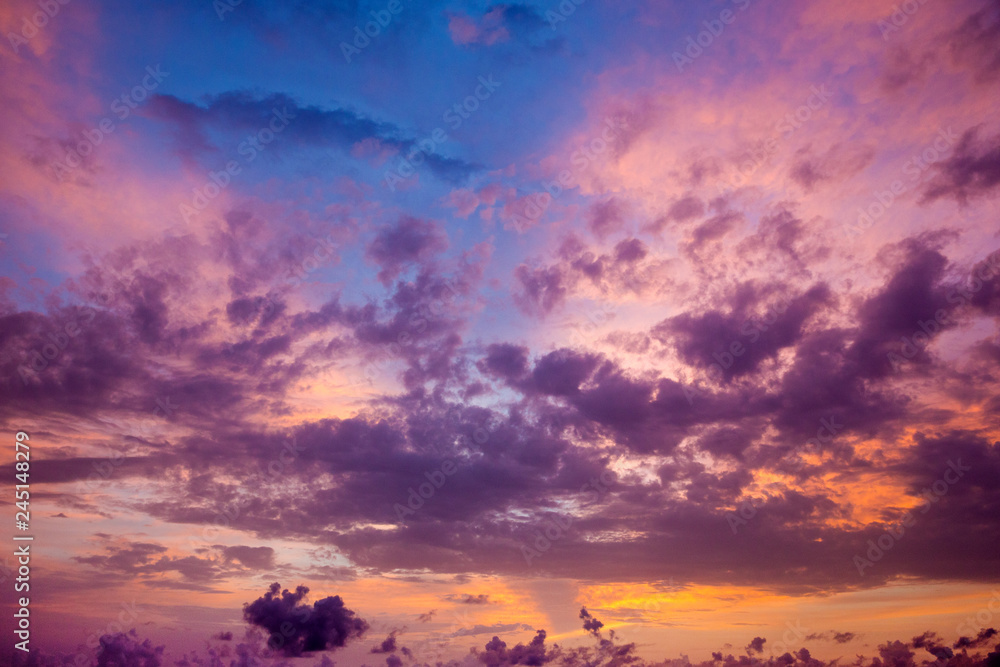 Sunset with sun rays, sky with clouds and sun.