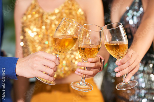 Champagne glasses in hands of people at party