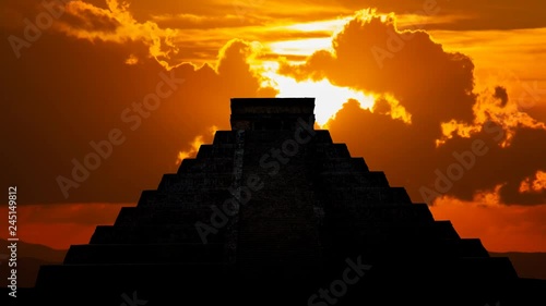 Mayan pyramid ( Kukulcan Temple ) at Sunset, Time Lapse with Red Sun and Clouds, Chichen Itza, Yucatan, Mexico photo