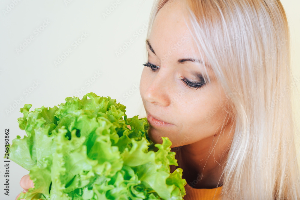 Portrait of an attractive girl with a salad Bush. Dieting concept. Portrait of an attractive girl with a salad Bush. Dieting concept.