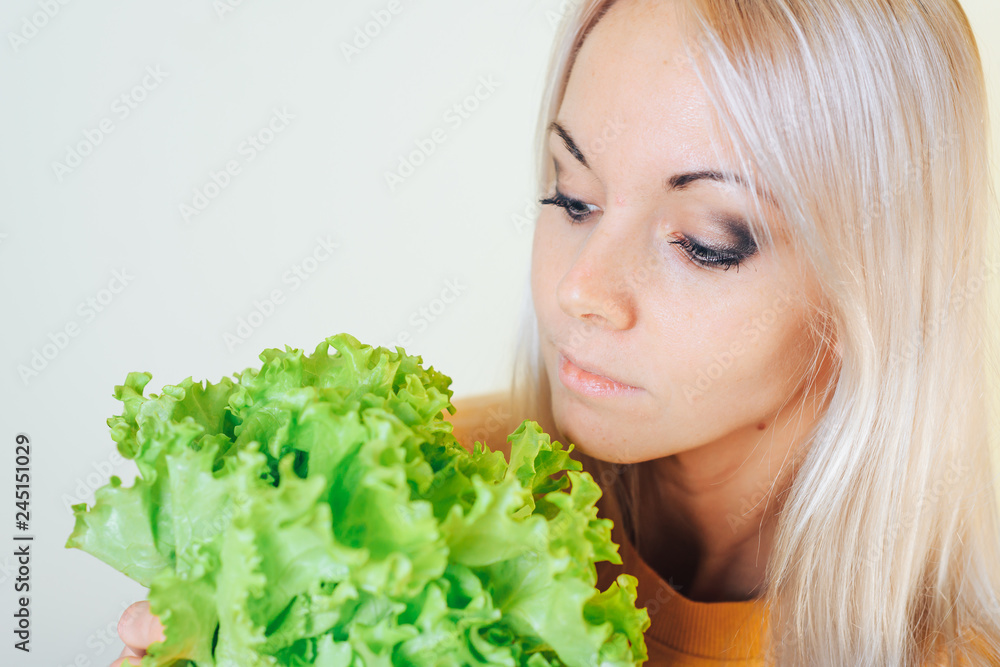Portrait of an attractive girl with a salad Bush. Dieting concept. Portrait of an attractive girl with a salad Bush. Dieting concept.