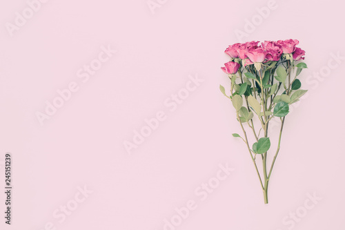 Flowers composition. Frame made of red rose on white wooden background. Flat lay, top view, copy space.