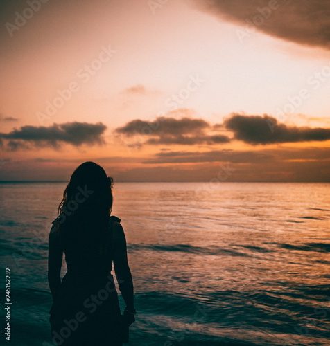 silhouette of girl at sunset © James