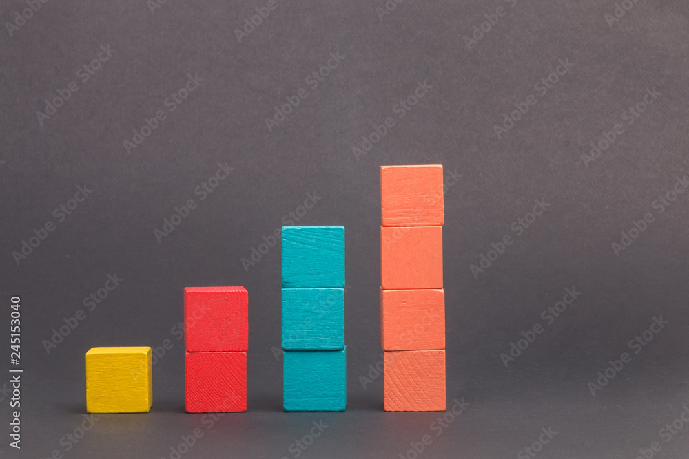 Toy wooden blocks as financial graph. Graph with four 4 steps. Growing ...