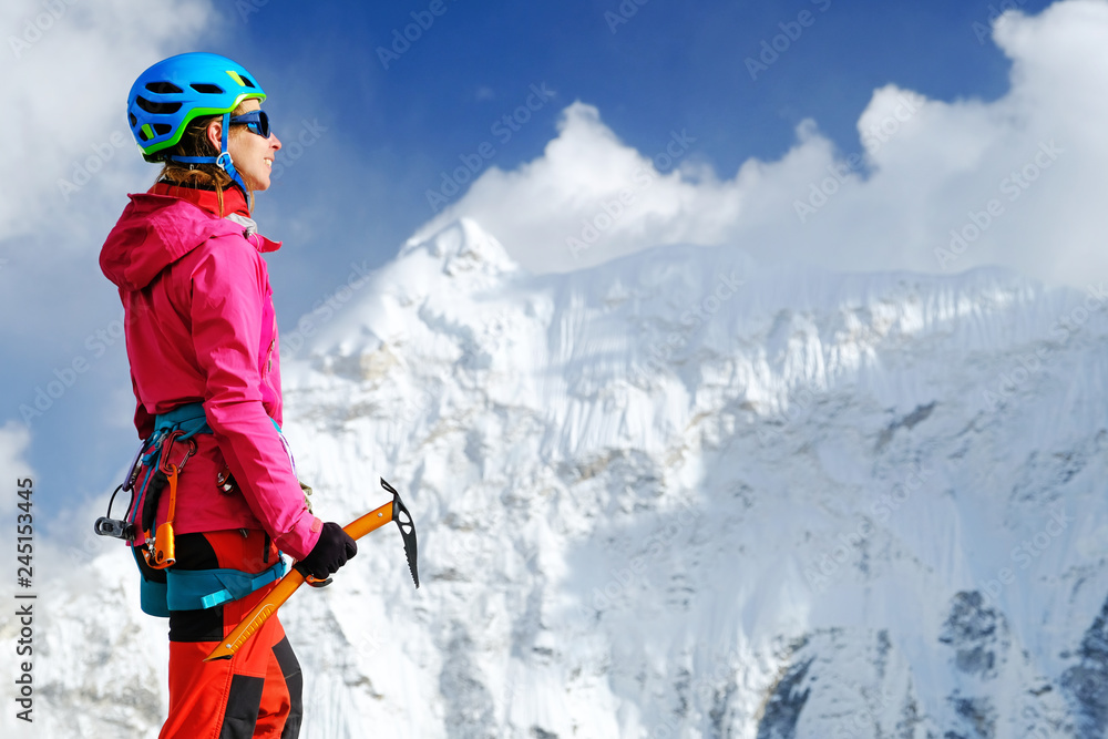 Climber reaches the summit of mountain peak. Success, freedom and happiness, achievement in mountains. Climbing sport concept.
