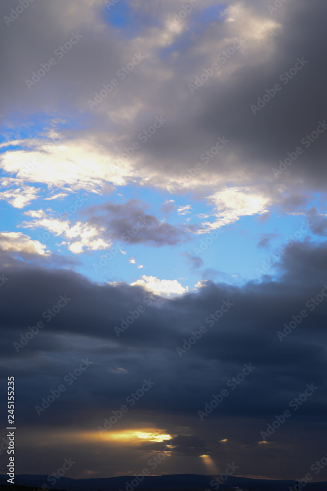 Obraz premium Dark sky clouds cloudscape over the sunset
