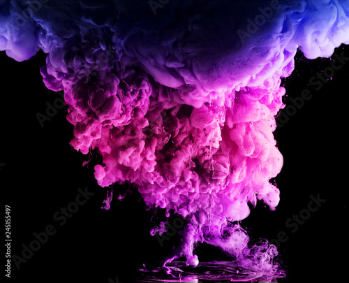 colored acrylic paint in water. the explosion of colours on a black background