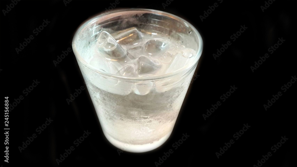 glass of water with ice on black background glass of water with ice on black background