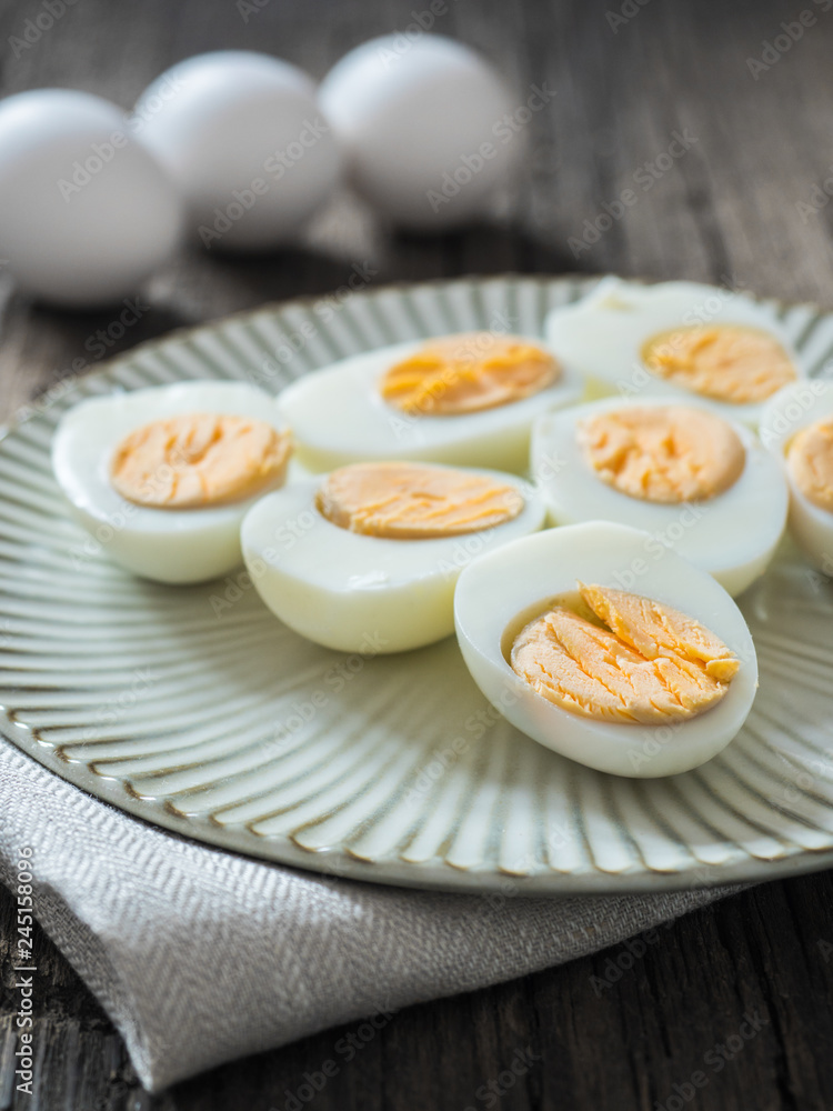 Boiled chicken eggs on a gray plate. Wooden background. The concept of Easter Boiled chicken eggs on a gray plate. Wooden background. The concept of Easter