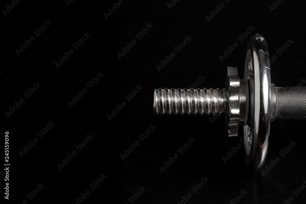 Detail of dumbbell with black background Detail of dumbbell with black background