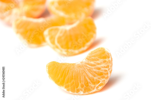 pieces of peeled tangerine on white background