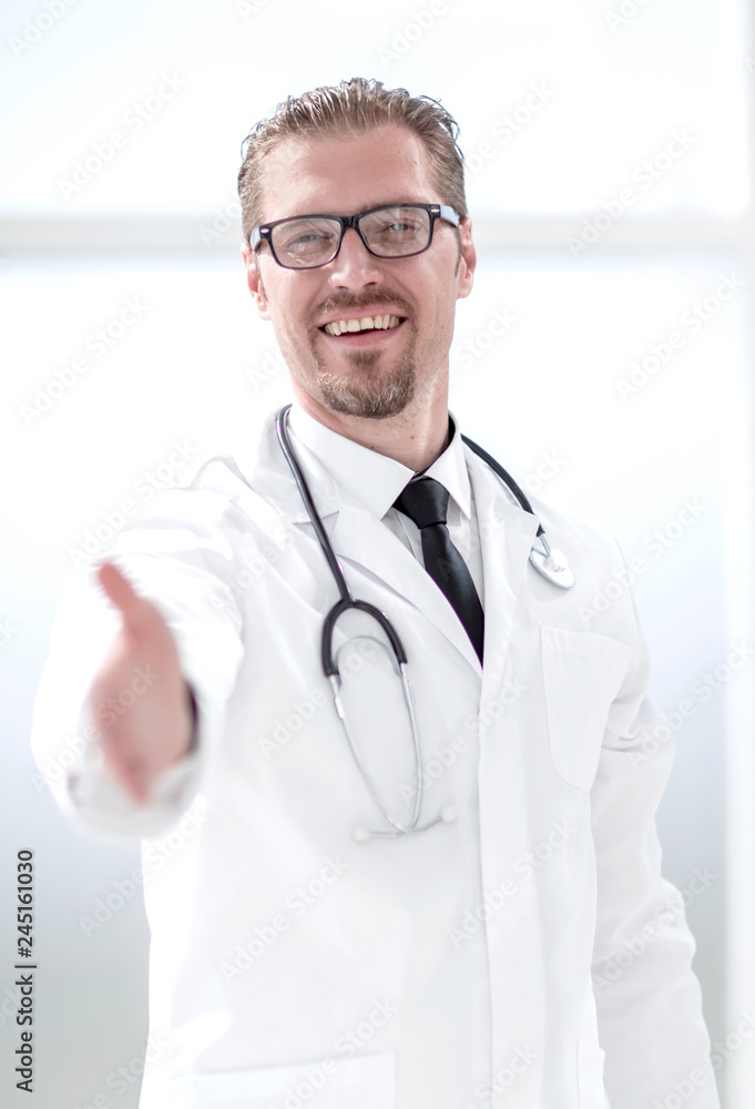 friendly doctor extending his hand for greeting friendly doctor extending his hand for greeting