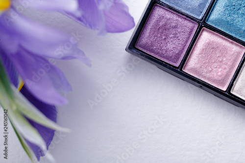 at lay palette with shades of spring pastel colours on a light background with flower of iris