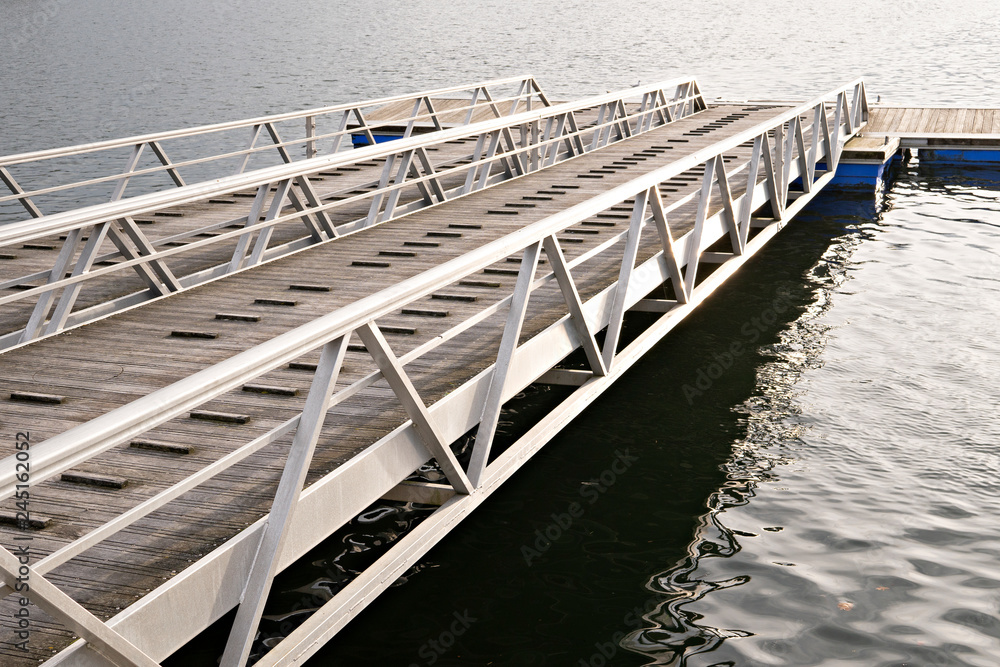 Modern wooden jetty or pier with metal sides without people or