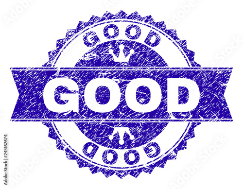GOOD rosette stamp imprint with grunge texture. Designed with round rosette, ribbon and small crowns. Blue vector rubber watermark of GOOD label with grunge texture.