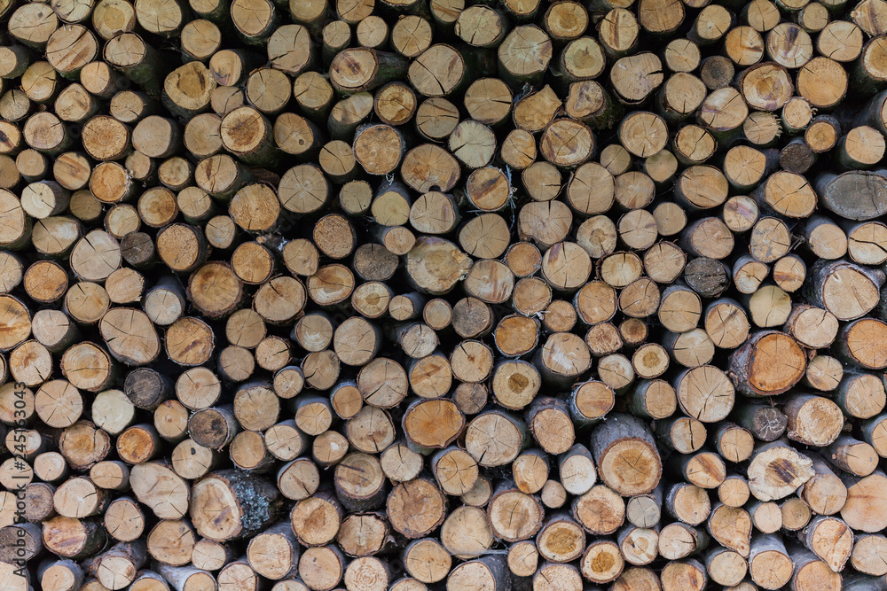 Background of dry chopped firewood logs stacked up on top of each other in a pile. Background of dry chopped firewood logs stacked up on top of each other in a pile.