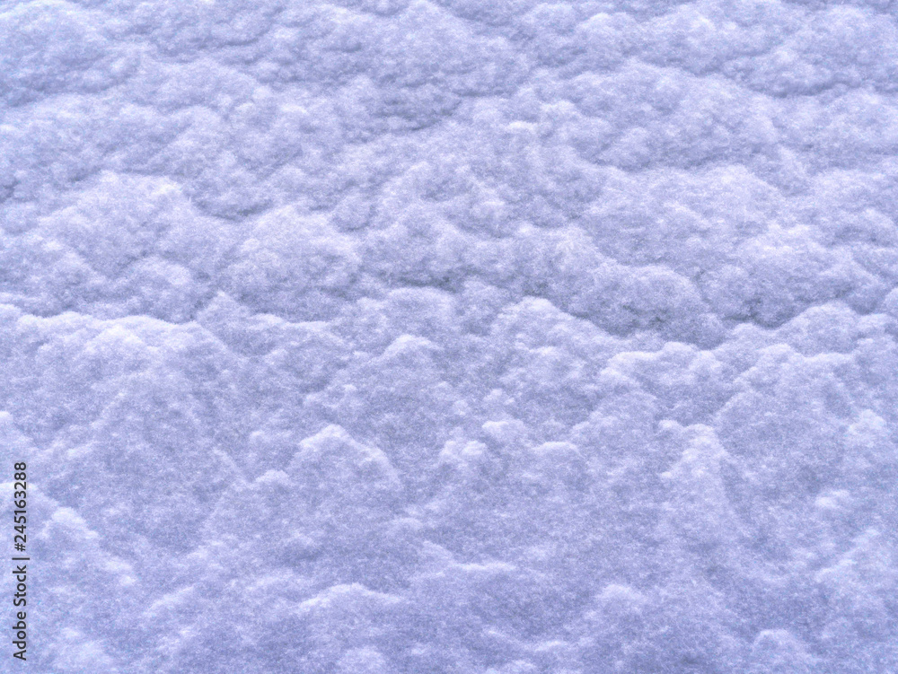 Texture of a snow-covered slope. small snow down poured a large snowdrift