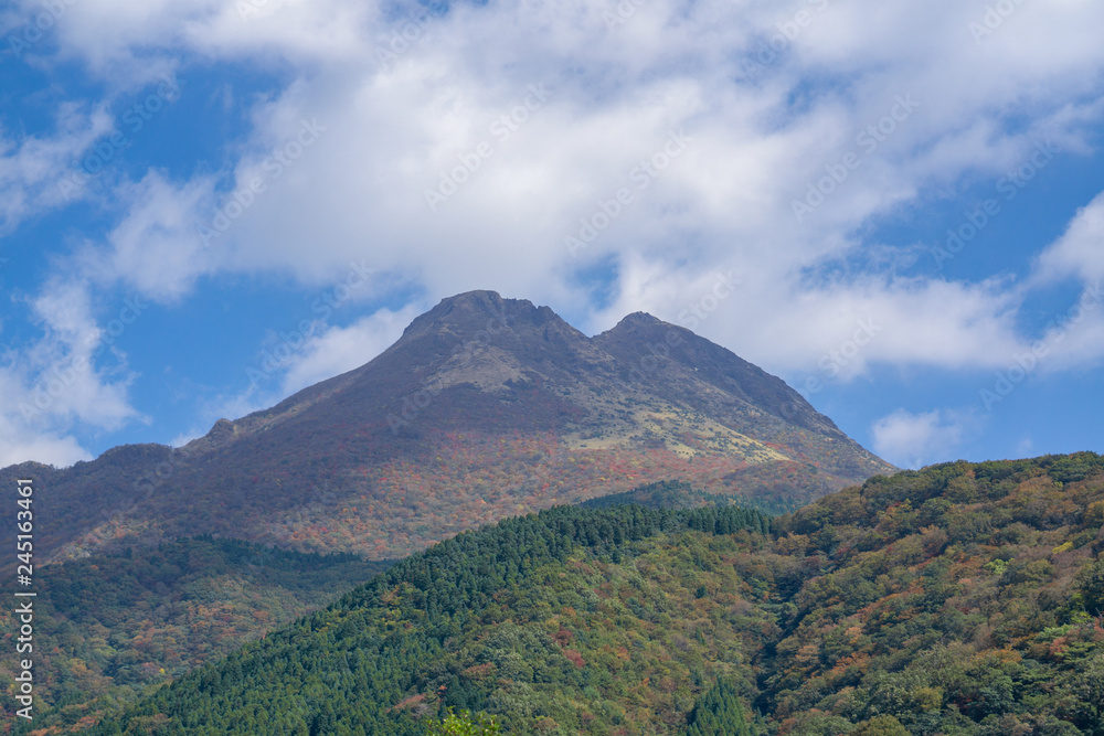 Beautiful lanscape panorama of Yufu mountain in Background and blue sky with clouds in autumn leaves. onsen town, Yufuin, Oita, Kyushu, Japan