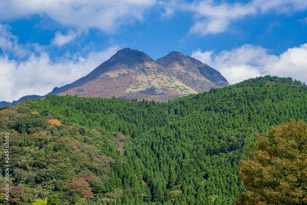 Beautiful lanscape panorama of Yufu mountain in Background and blue sky with clouds in autumn leaves. onsen town, Yufuin, Oita, Kyushu, Japan