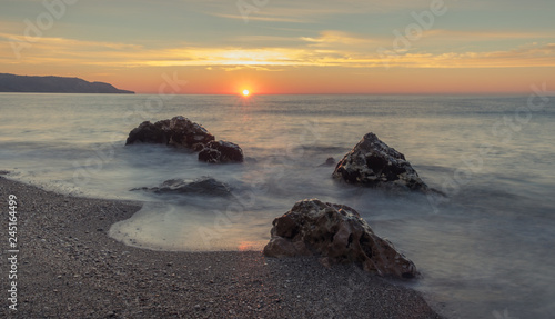 Nerja, Malaga, Andalusi, Spain - December 9, 2018: Nice sunrise on Burriana beach, village of Nerja, Spain